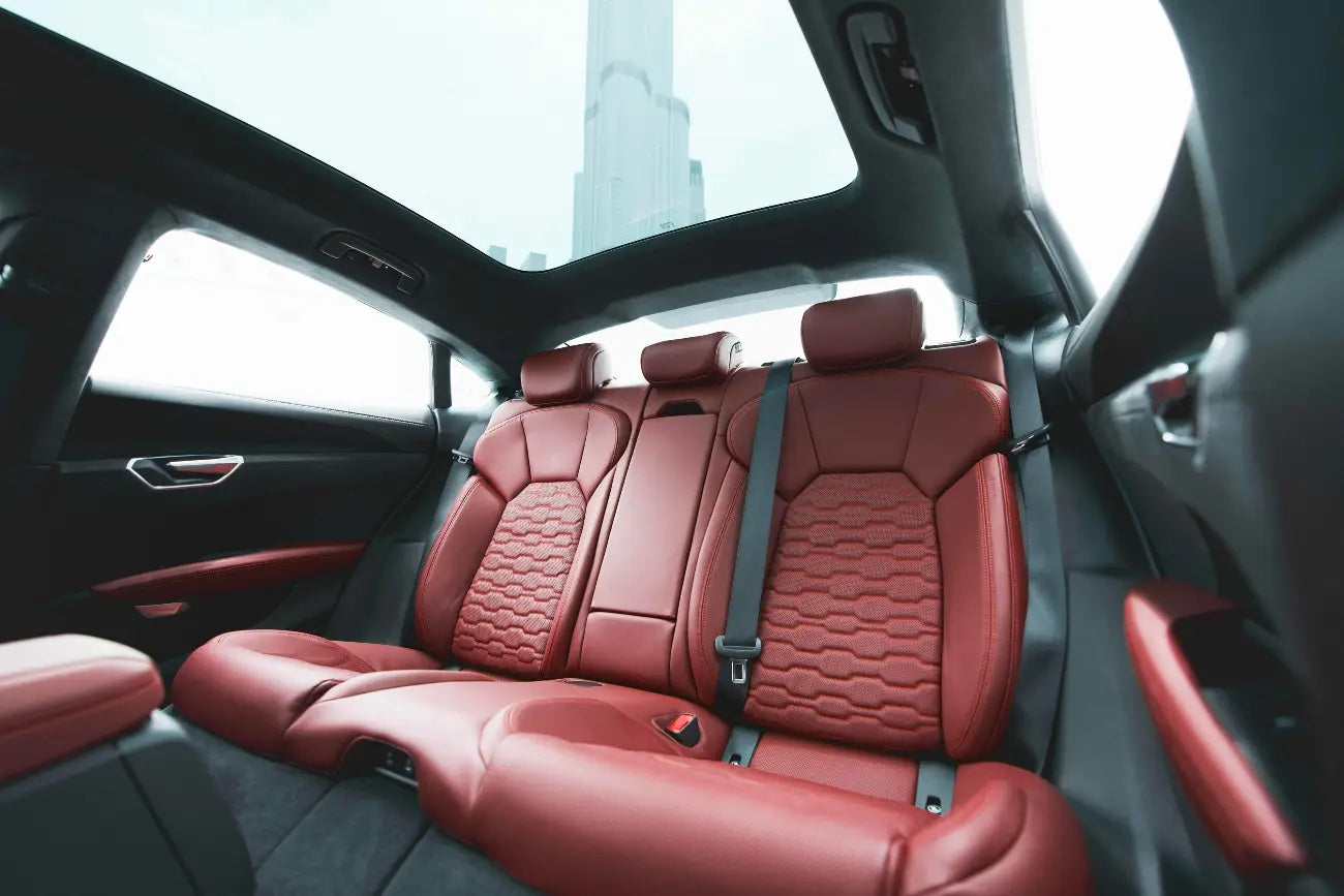 Audi E-Tron GT RS under the dazzling Dubai skyline, epitomizing modern luxury car rental options.