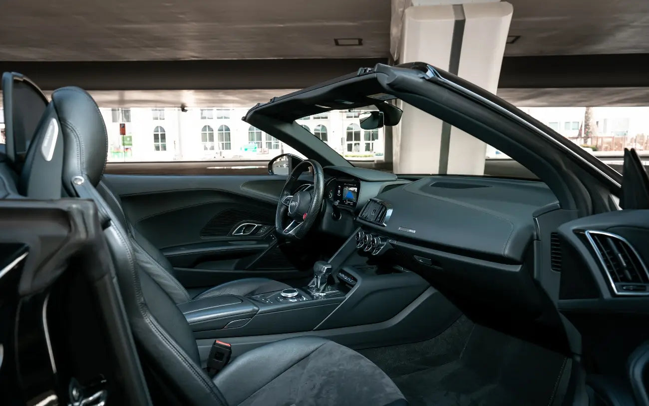 Audi R8 V10 Spyder convertible top down, ready for an exhilarating drive down Dubai's iconic roads.