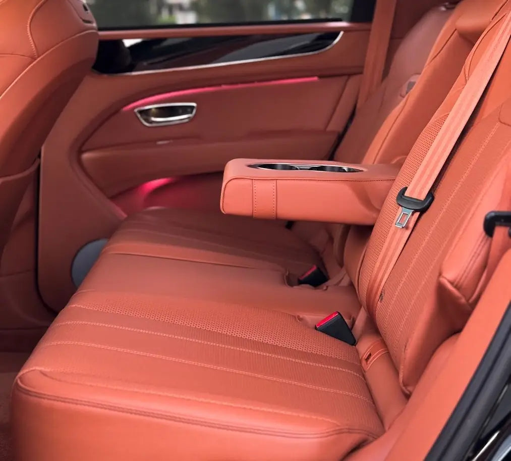 Panoramic view of Bentley Bentayga parked before Dubai's skyline, representing the ultimate luxury SUV rental experience.