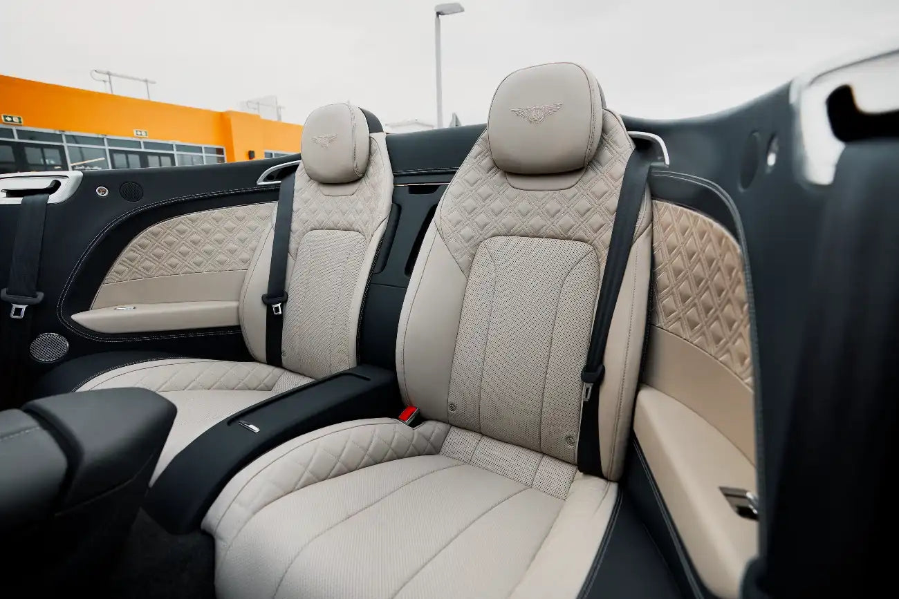 Bentley Continental GTC cruising on Dubai streets, a top choice for high-end car rental.