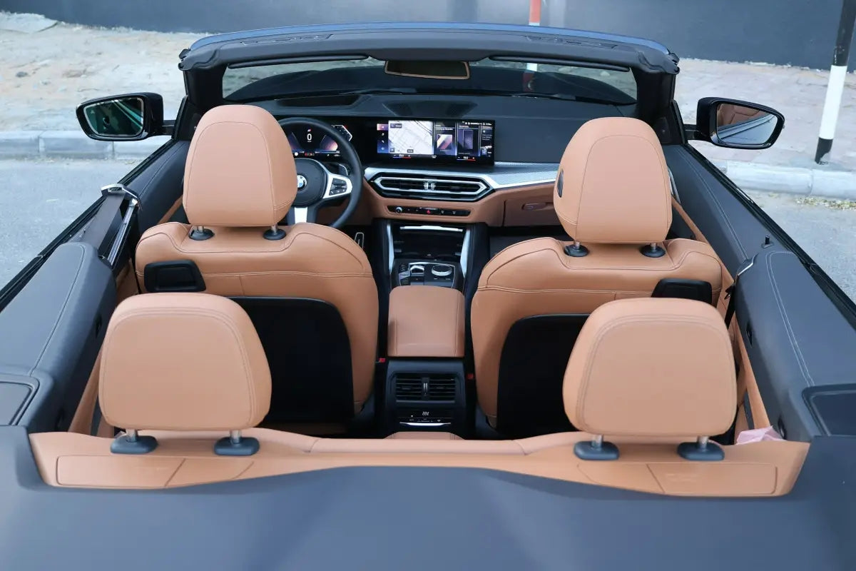 Night view of BMW 420i Convertible with city lights, showcasing the ultimate luxury rental experience in Dubai.