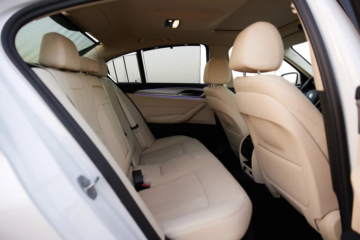 Close-up of BMW 520i headlights and grille, symbolizing premium Dubai car rental options.