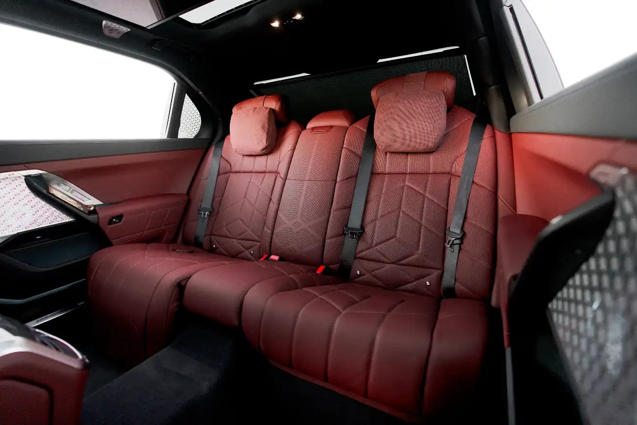 Night view of BMW 740i with headlights on, highlighting its presence and allure for nighttime driving in Dubai.