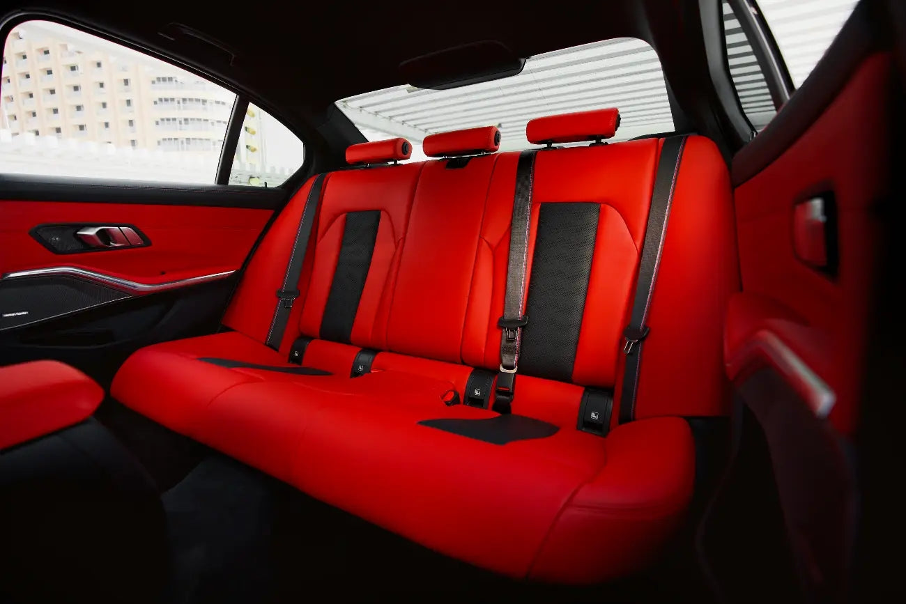 BMW M3 Competition cruising on Dubai's roads, epitomizing luxury and performance in car rentals.