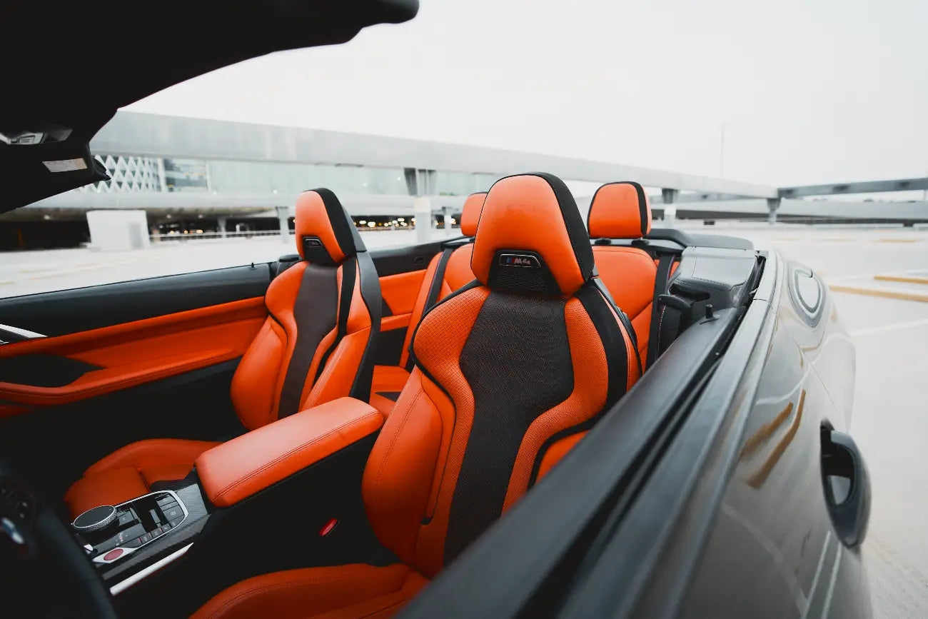 Driver's perspective inside a BMW M4 Competition, showcasing the dashboard and cockpit, ready for rent in Dubai.