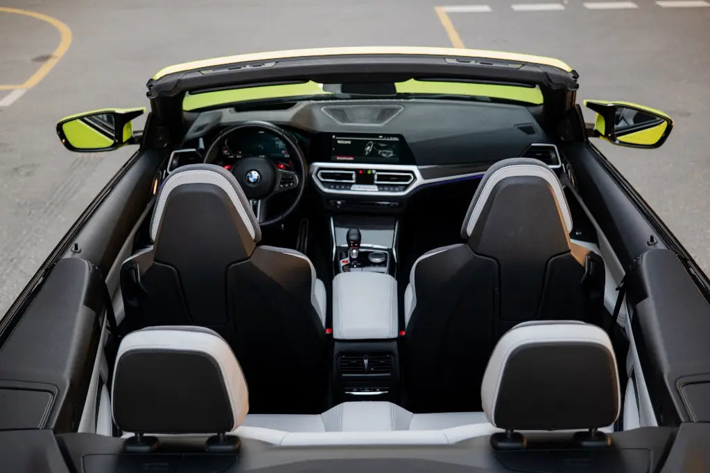 Top-down view of a BMW M4 Competition luxury convertible, capturing its sleek lines and elegant design, available for rent in Dubai.