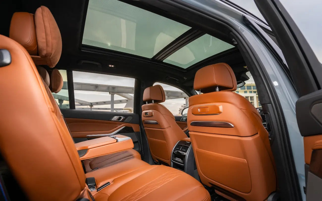 Night-time image of a BMW X7 40i with headlights on, illuminating its path, a perfect representation of luxury car rentals in Dubai.