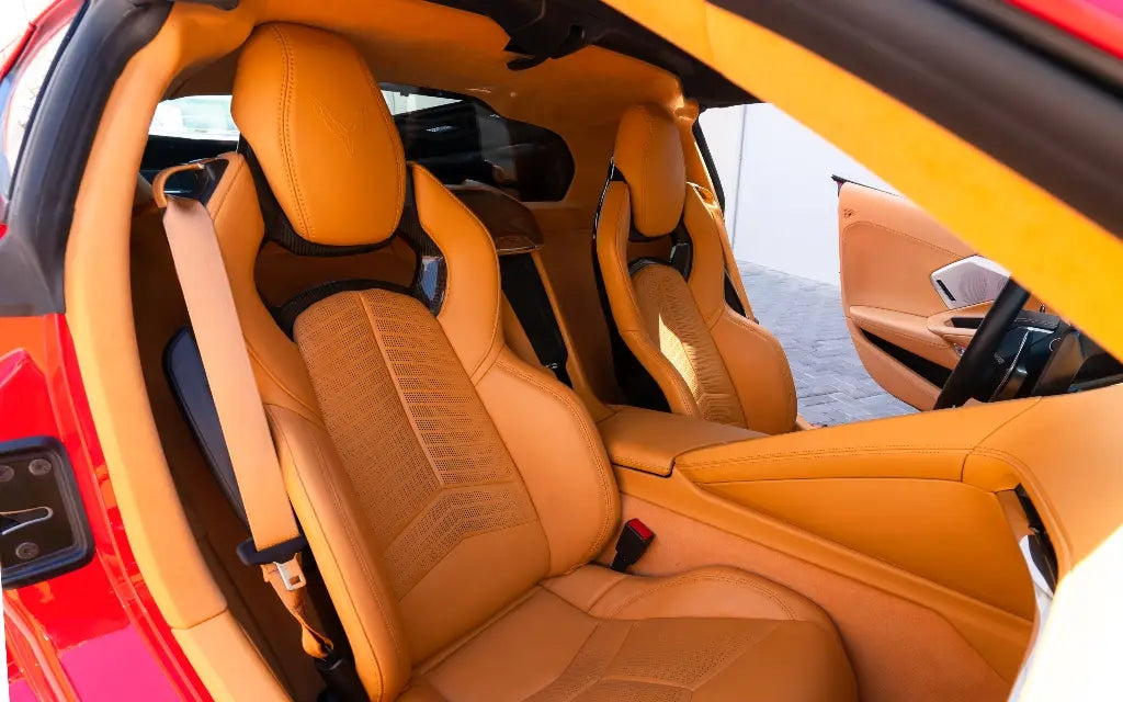 Close-up on the Chevrolet Corvette C8 Spyder's wheels and sleek lines, available for rent in Dubai's luxury car scene.