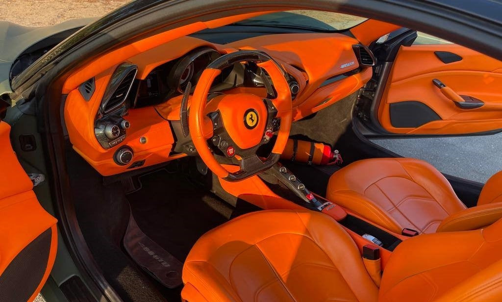 Close-up of the Ferrari 488's powerful engine, a top pick for performance car rentals in Dubai.