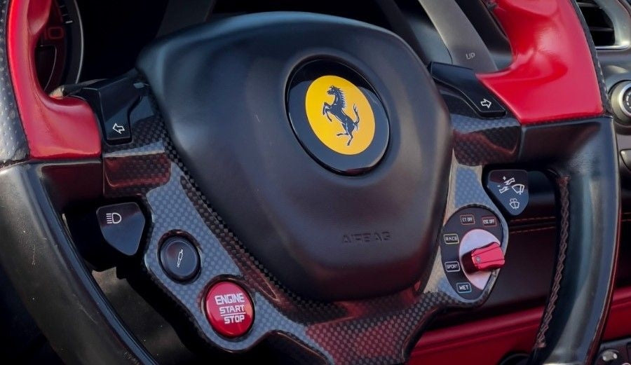 Top-down view of a convertible Ferrari 488 Spyder, perfect for cruising the streets of Dubai in style and luxury.