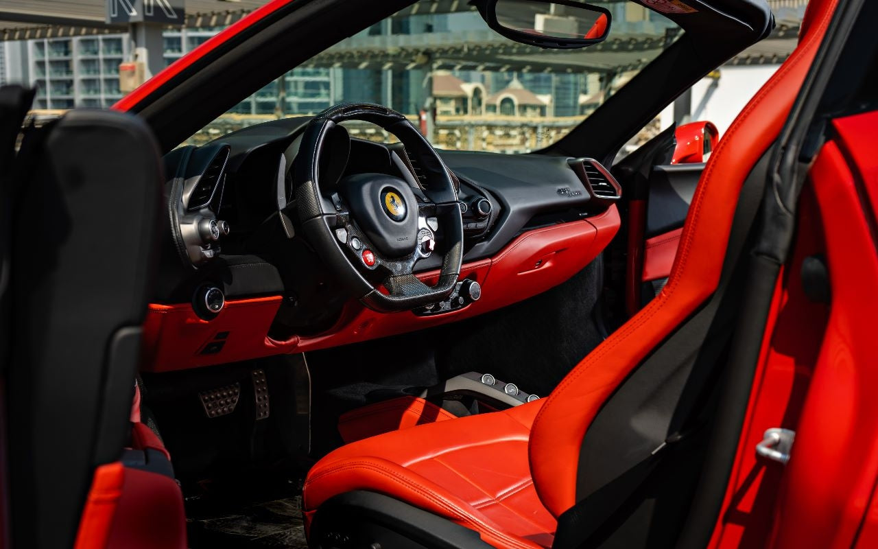 Ferrari 488 Spyder convertible with the top down, ready for a sun-soaked drive, available for rent in the heart of Dubai.