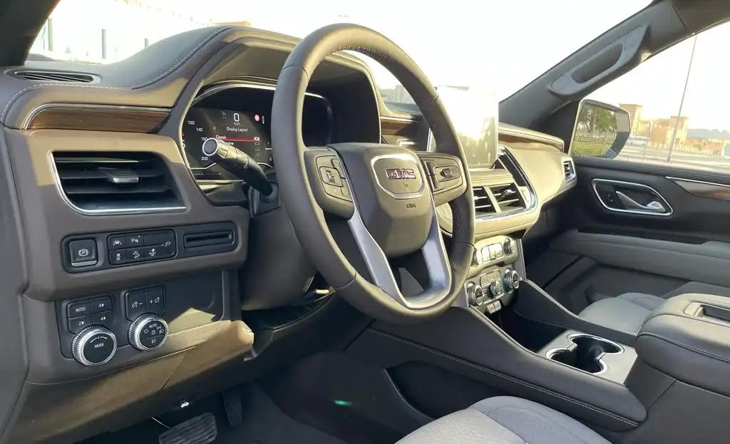 GMC Yukon navigating the desert landscape near Dubai, a top choice for luxury SUV rentals.