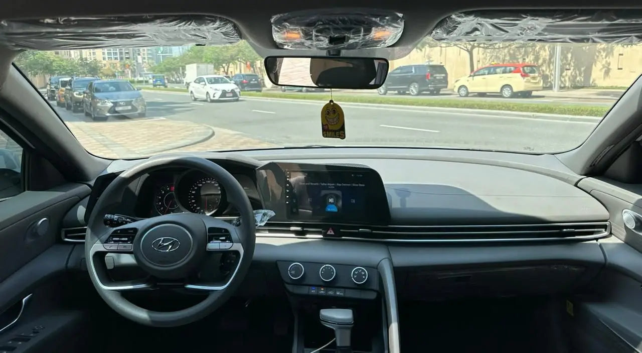 Hyundai Elantra in action on Dubai roads, demonstrating smooth ride and superior handling for renters.