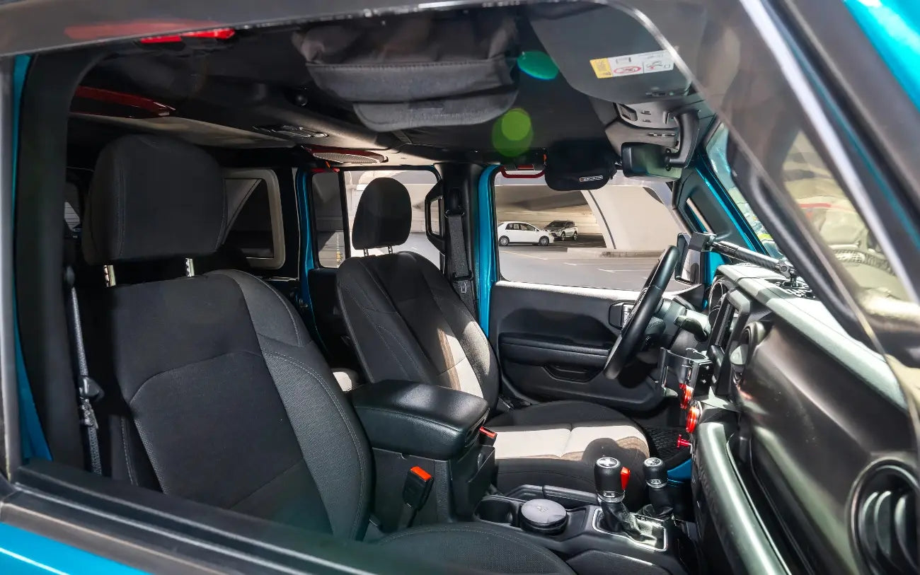 Jeep Wrangler's signature grille and headlights, symbolizing luxury off-road capability in Dubai.