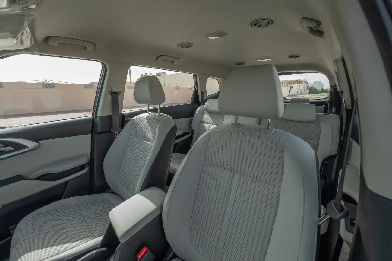 KIA Carens under the vibrant Dubai skyline, the go-to economy vehicle for exploring the city in style and comfort.