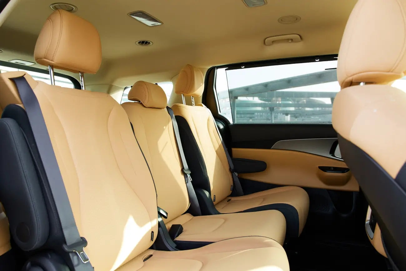 Close-up of KIA Carnival's high-end finishes and materials, epitome of luxury van rentals in Dubai.