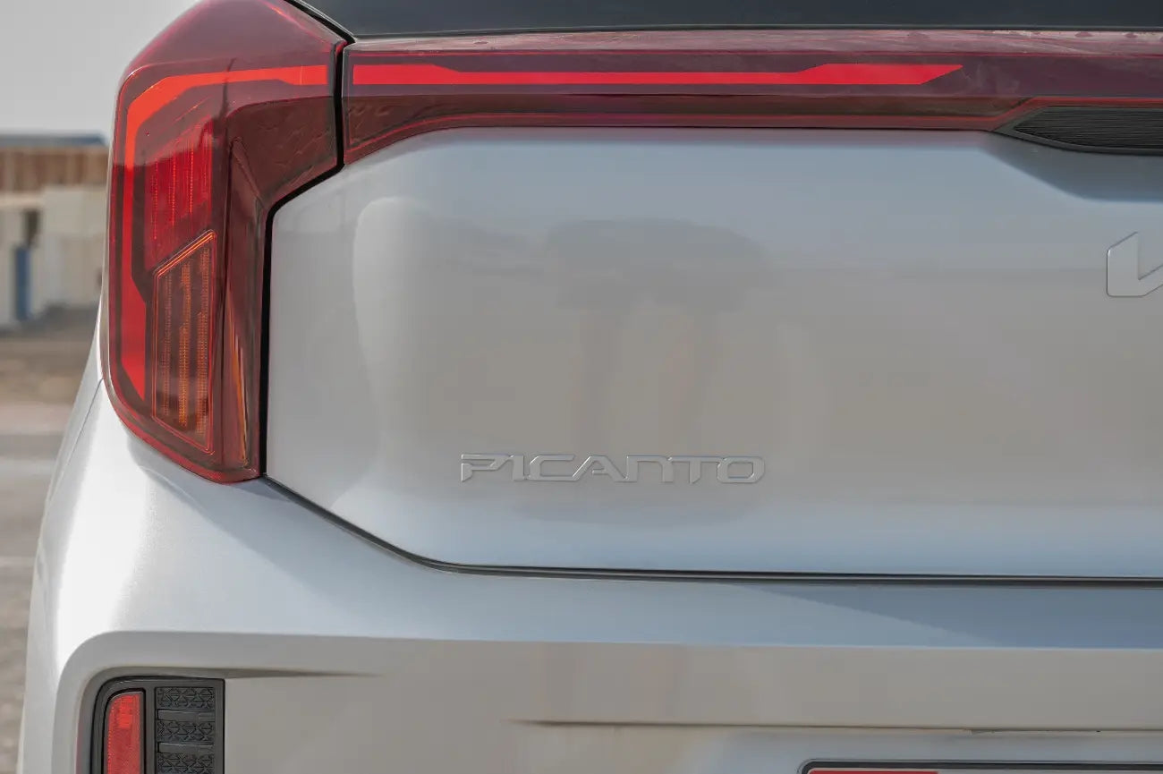 Driver's seat and cockpit area of KIA Picanto, a top choice for Dubai economy car rentals.