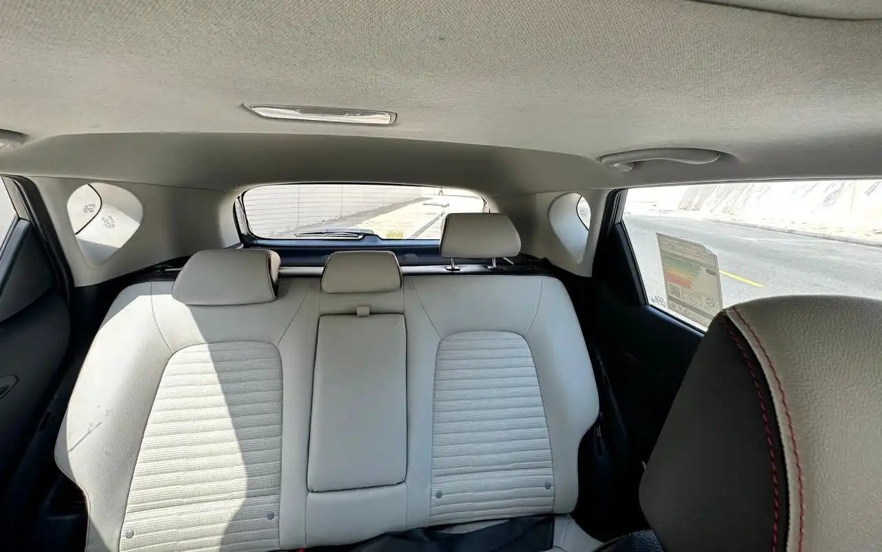 KIA Sonet Full Option parked in front of iconic Dubai skyline, epitomizing affordable luxury car rental options.