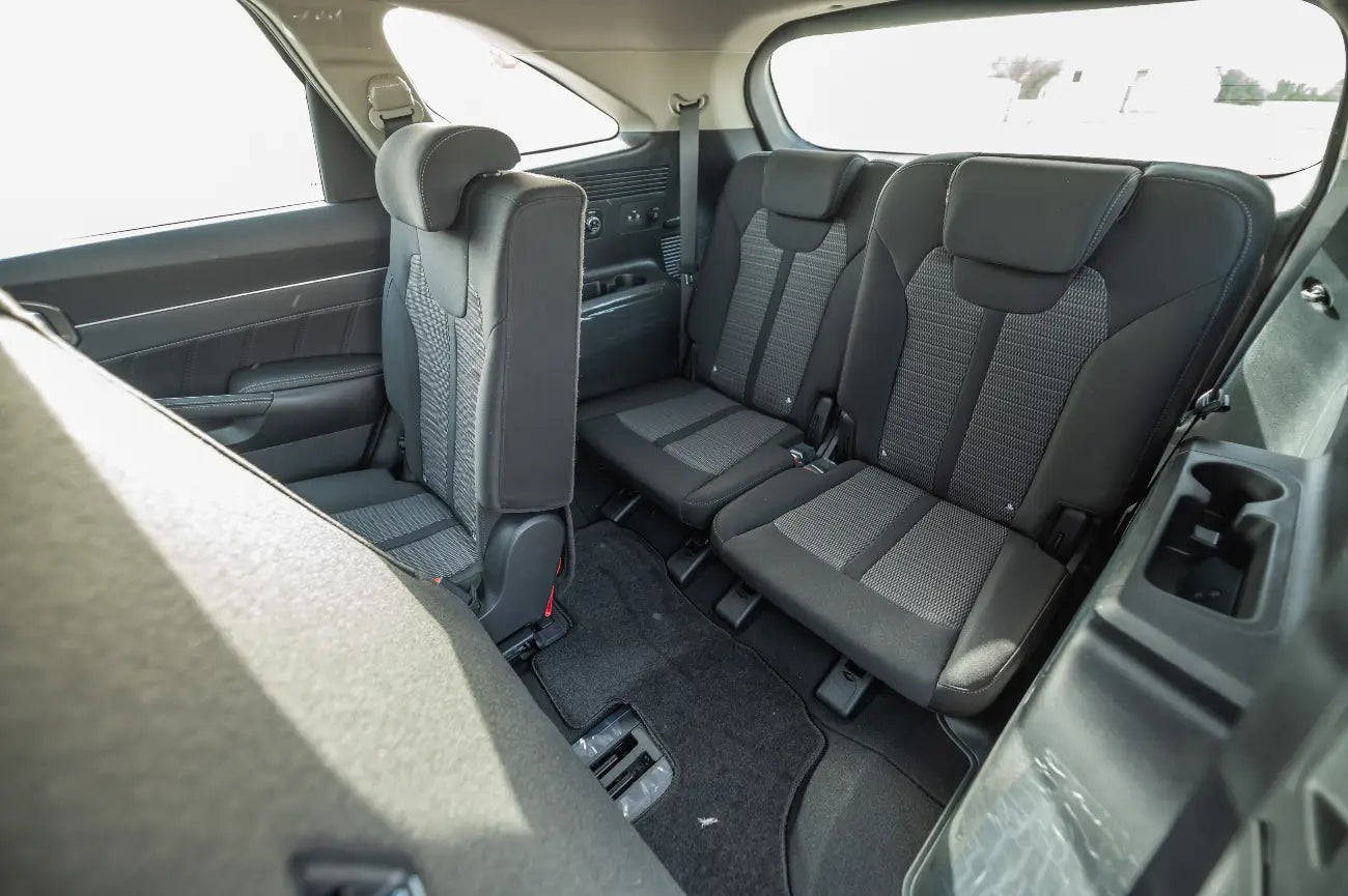 KIA Sorento side profile under the Dubai skyline, epitomizing affordable luxury rentals.