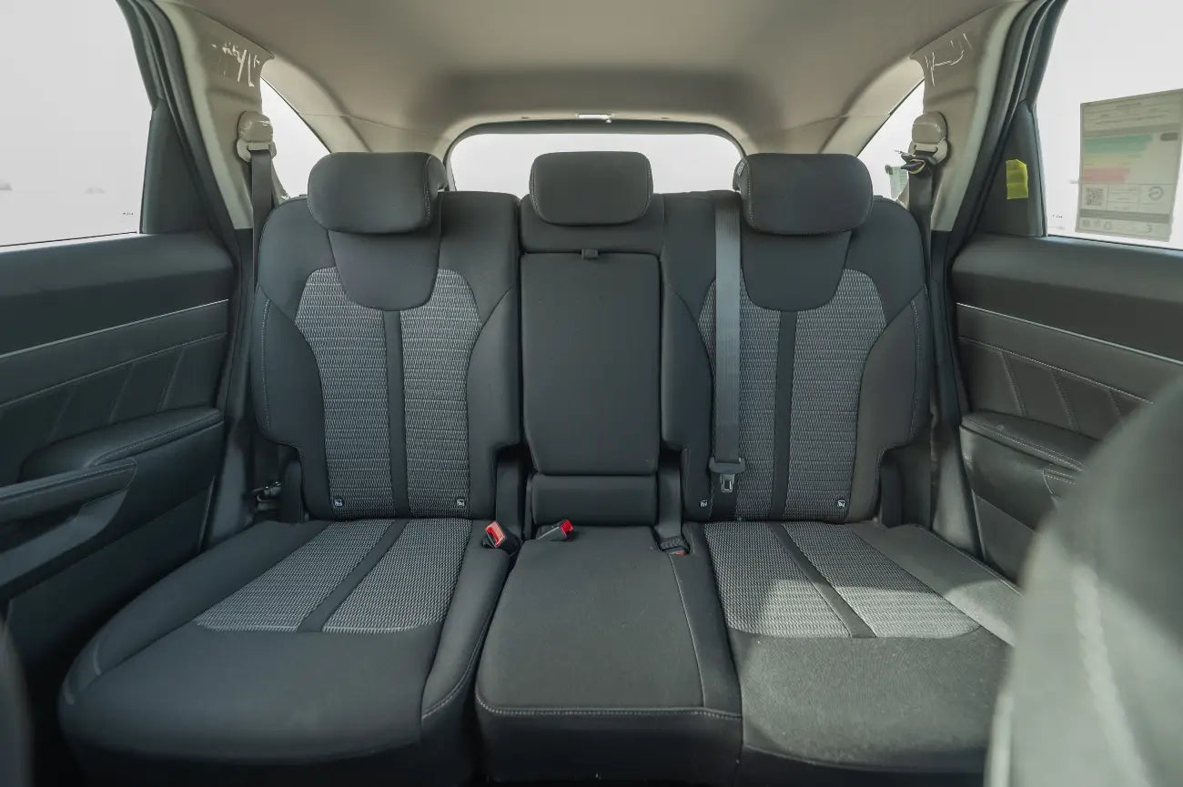 Night view of a KIA Sorento under Dubai's city lights, a top choice for luxury SUV rentals.