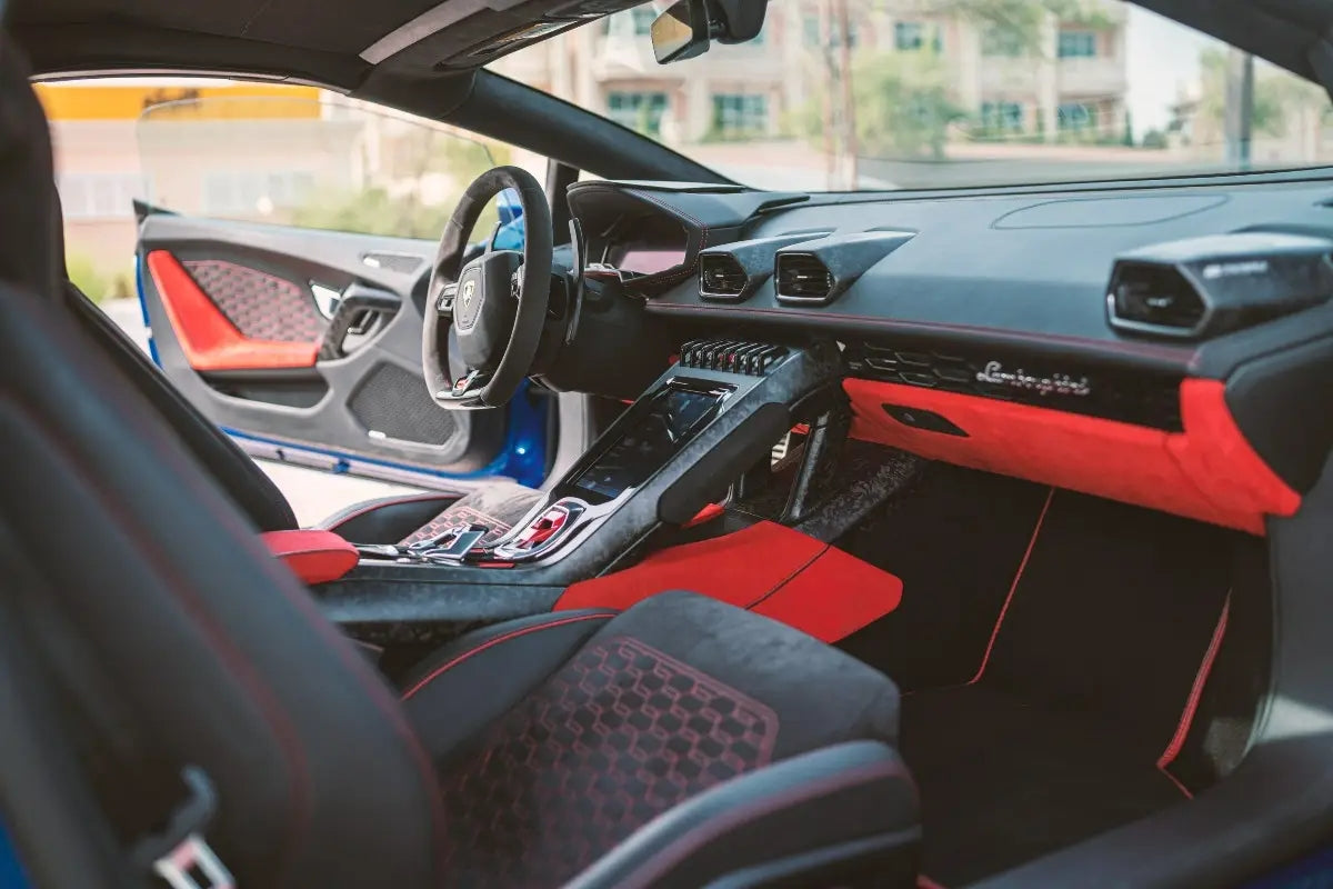 Close-up of the iconic Lamborghini badge on a Huracan EVO Spyder, symbolizing luxury and performance in Dubai car rentals.