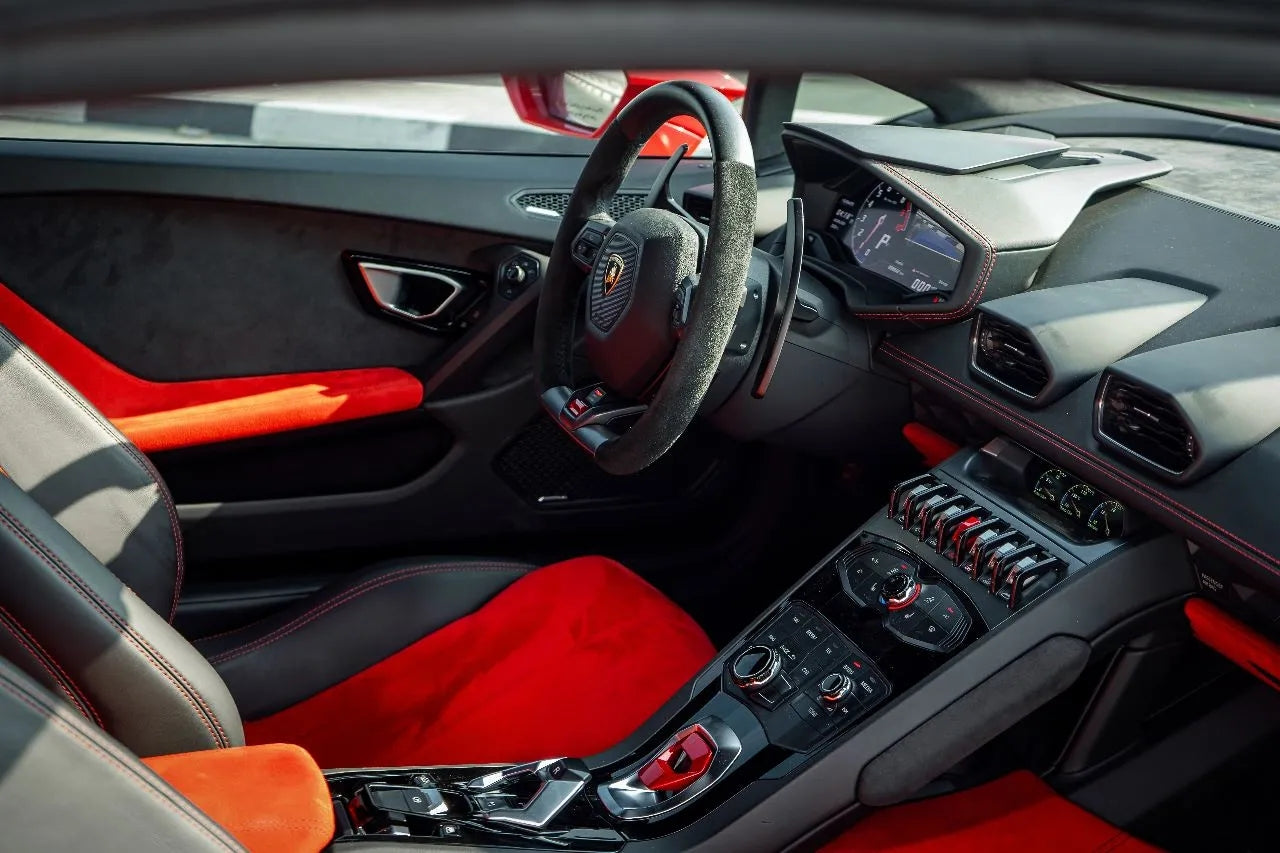 Side profile of the Lamborghini Huracan Spyder against Dubai skyline, epitomizing luxury car rental elegance and performance.