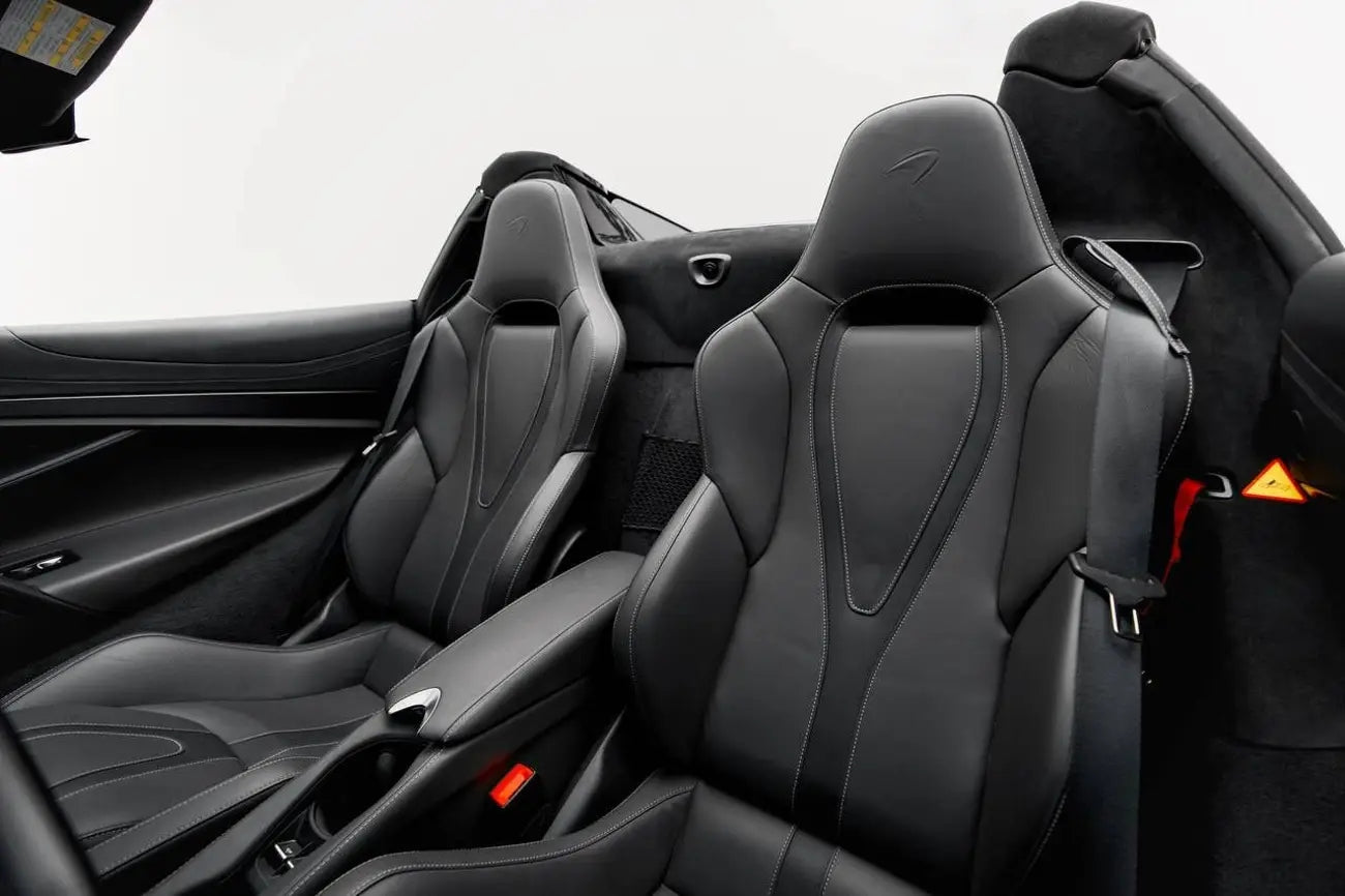 Close-up of the McLaren 720s dashboard and steering wheel, emphasizing luxury rental options in Dubai.