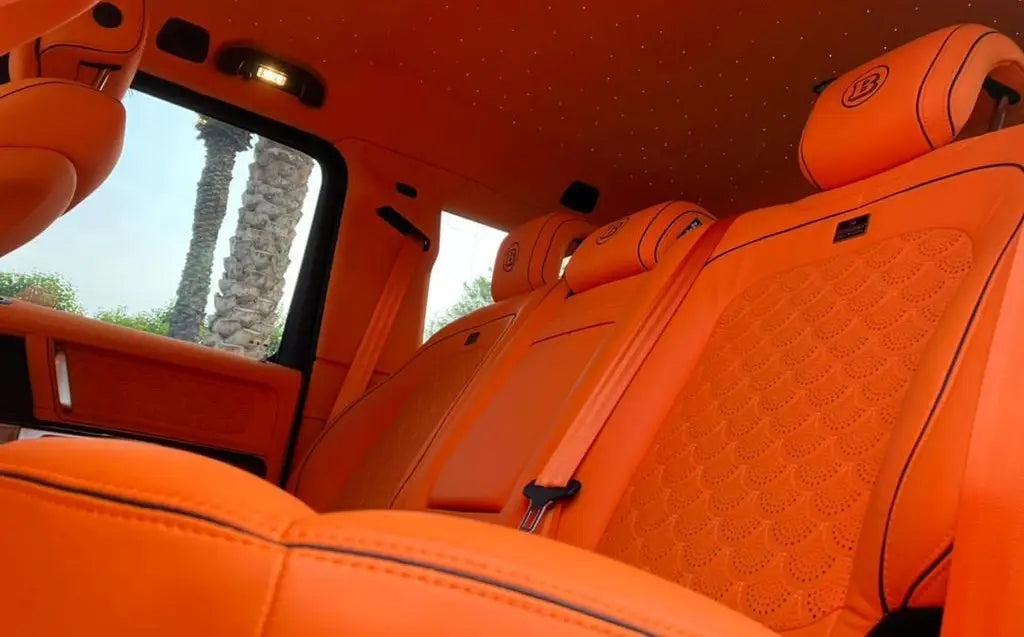 Dynamic night shot of a Mercedes Benz AMG G800 Brabus driving through Dubai, highlighting the luxury SUV's elegance and power for those looking to rent.