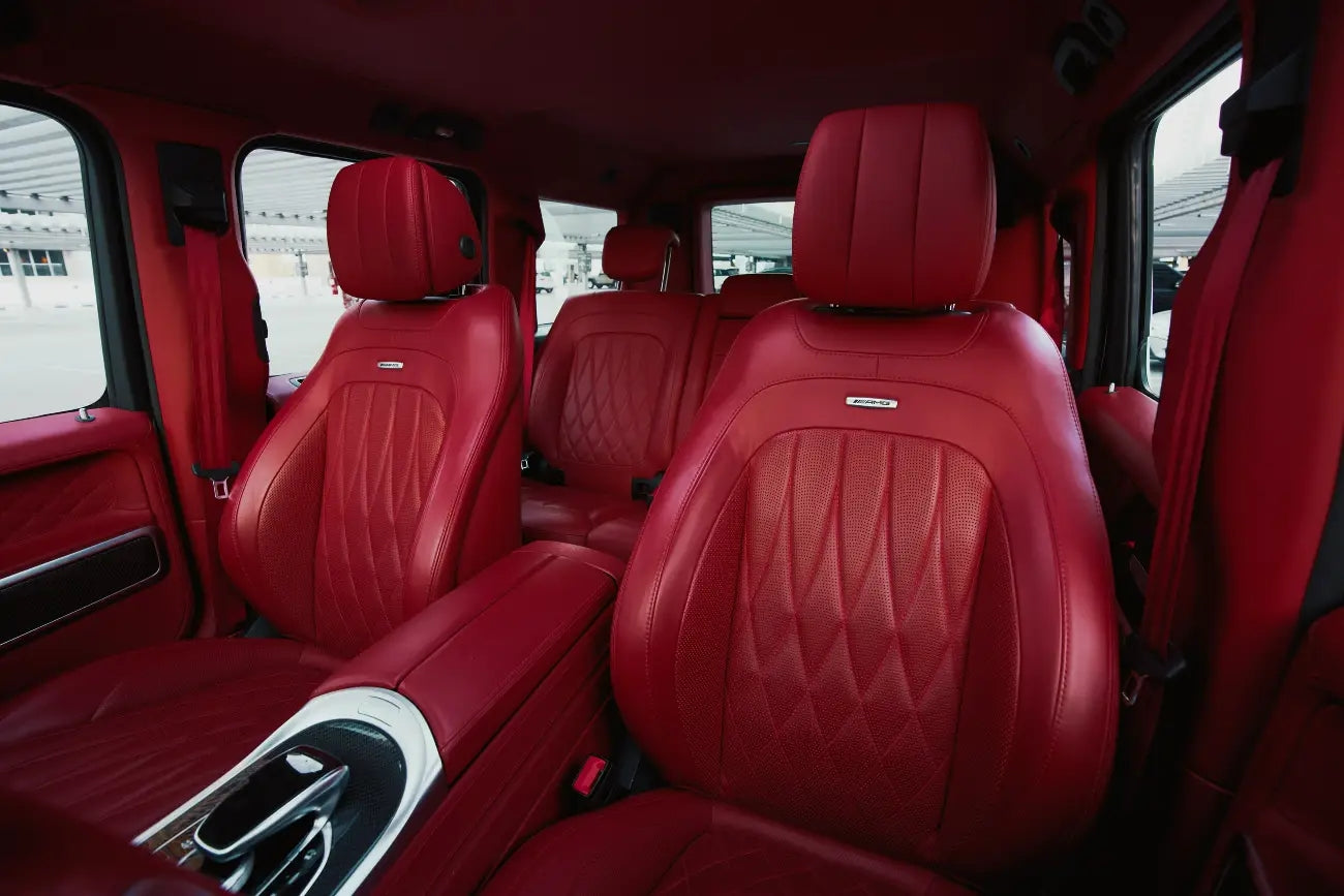 Mercedes Benz G63 cruising on Dubai's roads, epitomizing luxury and power in a high-end SUV rental service.