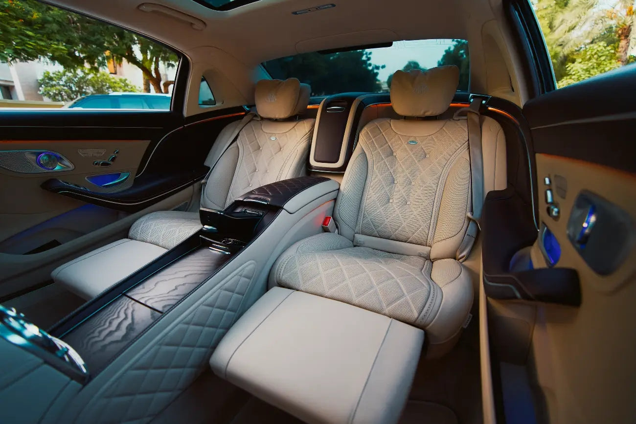 Mercedes Benz Maybach S650 parked by Dubai's waterfront, showcasing the vehicle's grandeur and appeal for high-end rentals.