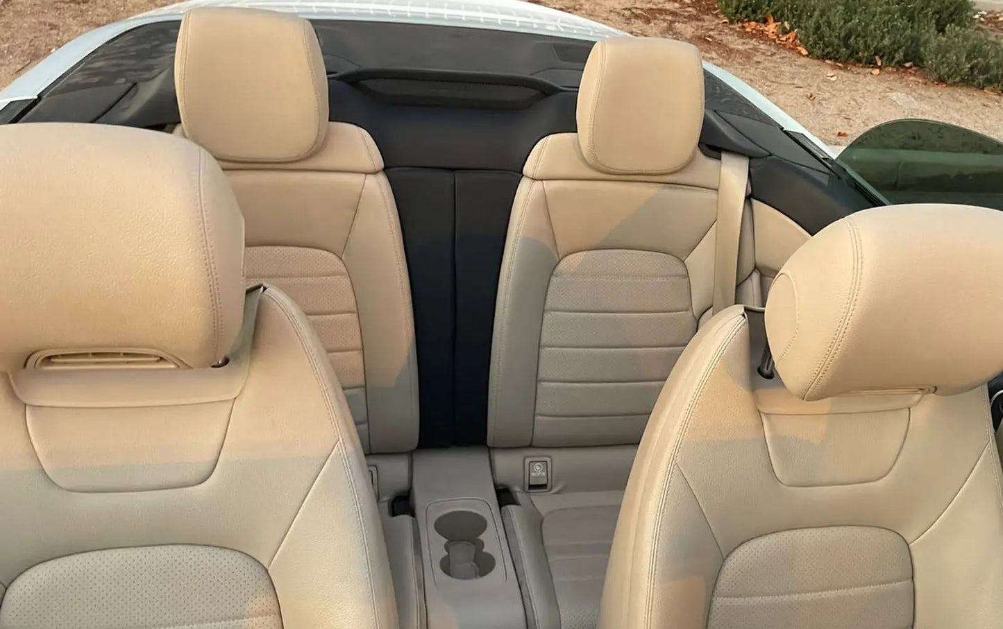 Driver's perspective inside a Mercedes C300 Convertible, featuring high-end finishes and dashboard for rent in Dubai.