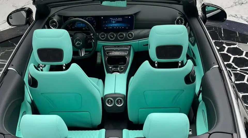 Close-up of Mercedes E53 AMG's front grille and badge, symbolizing luxury car rental in Dubai.