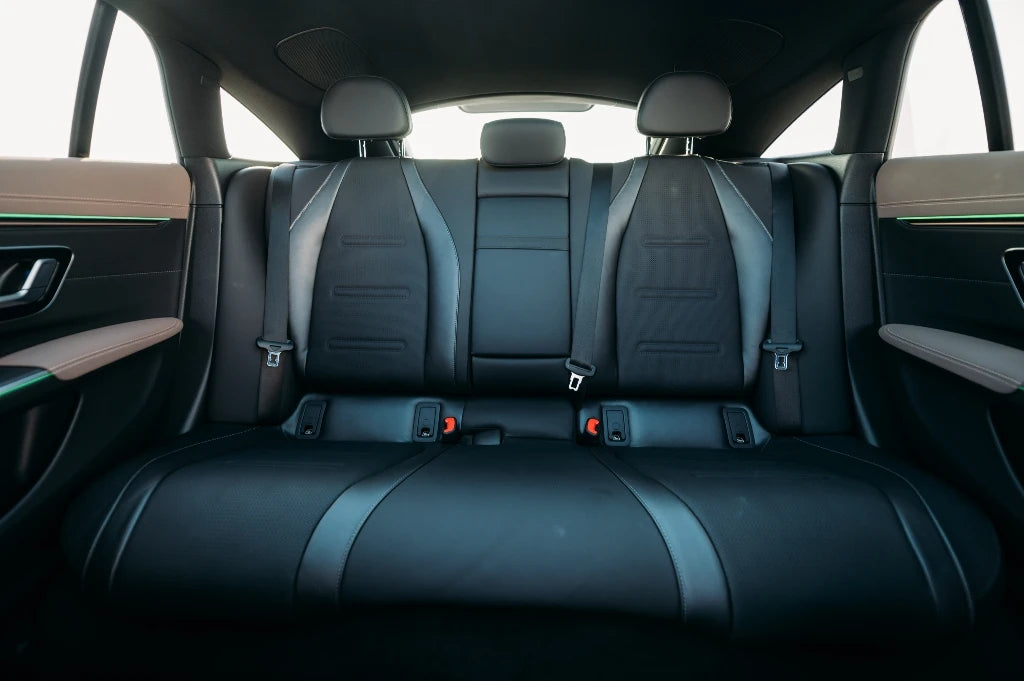 Front grille and emblem detail of the Mercedes EQS 53 AMG, symbolizing luxury and innovation available for rental in Dubai.