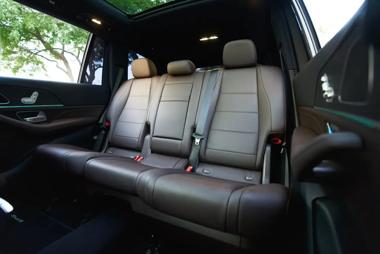 Immaculate Mercedes GLS 450 parked by Dubai skyline, representing the ultimate in luxury SUV rental experiences.