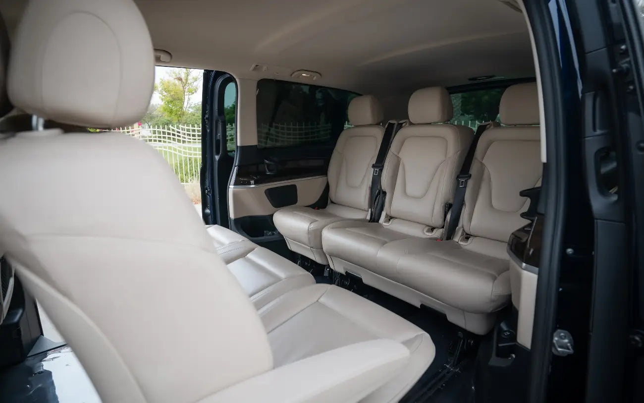 Mercedes V250 under the night lights of Dubai, showcasing the van's appeal for evening event transportation rentals.