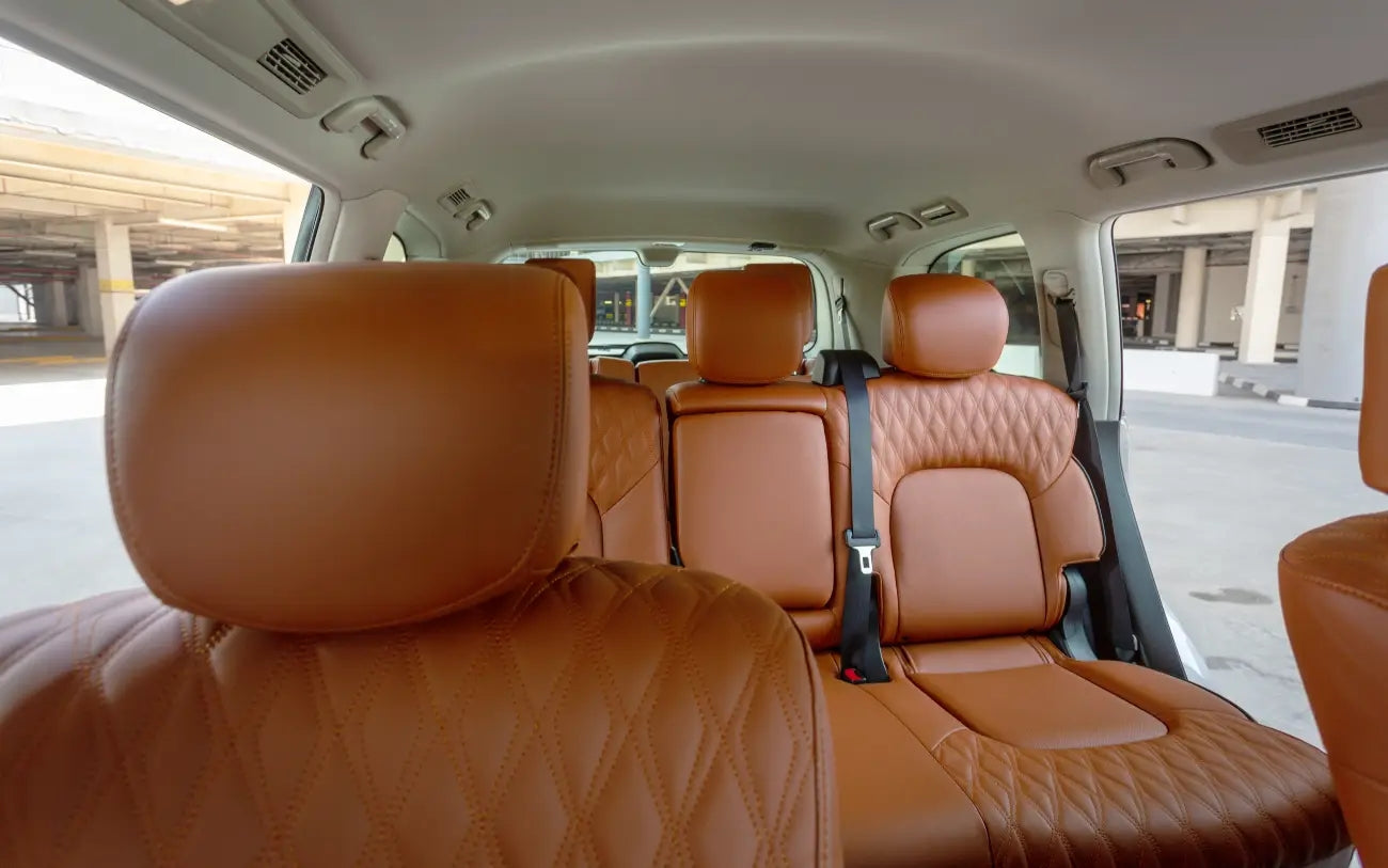 Side profile of the luxurious Nissan Patrol V6, parked and ready for rent in Dubai's elite districts.