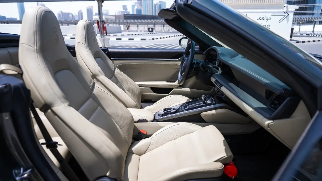 Dynamic side view of Porsche 911 Carrera Cabrio in motion, a premier choice for sports car enthusiasts in Dubai.