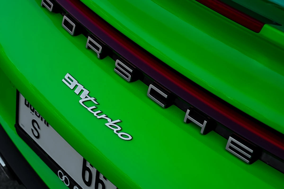 Elegant Porsche 911 Turbo with open doors, inviting you to experience luxury rentals in Dubai.