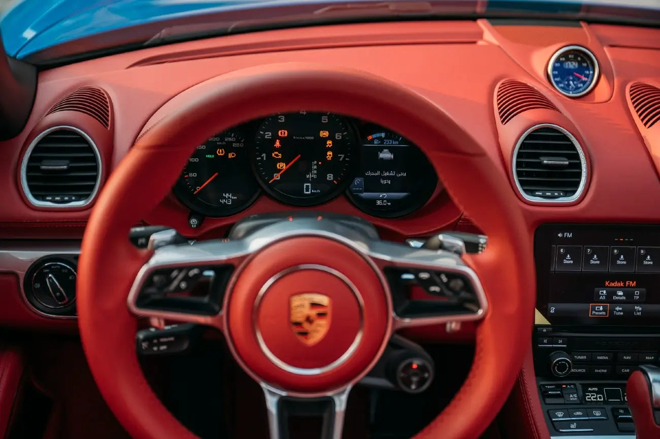 Porsche Boxster 718 Style Edition in motion, capturing the thrill of driving a top-tier sports car rental in Dubai.