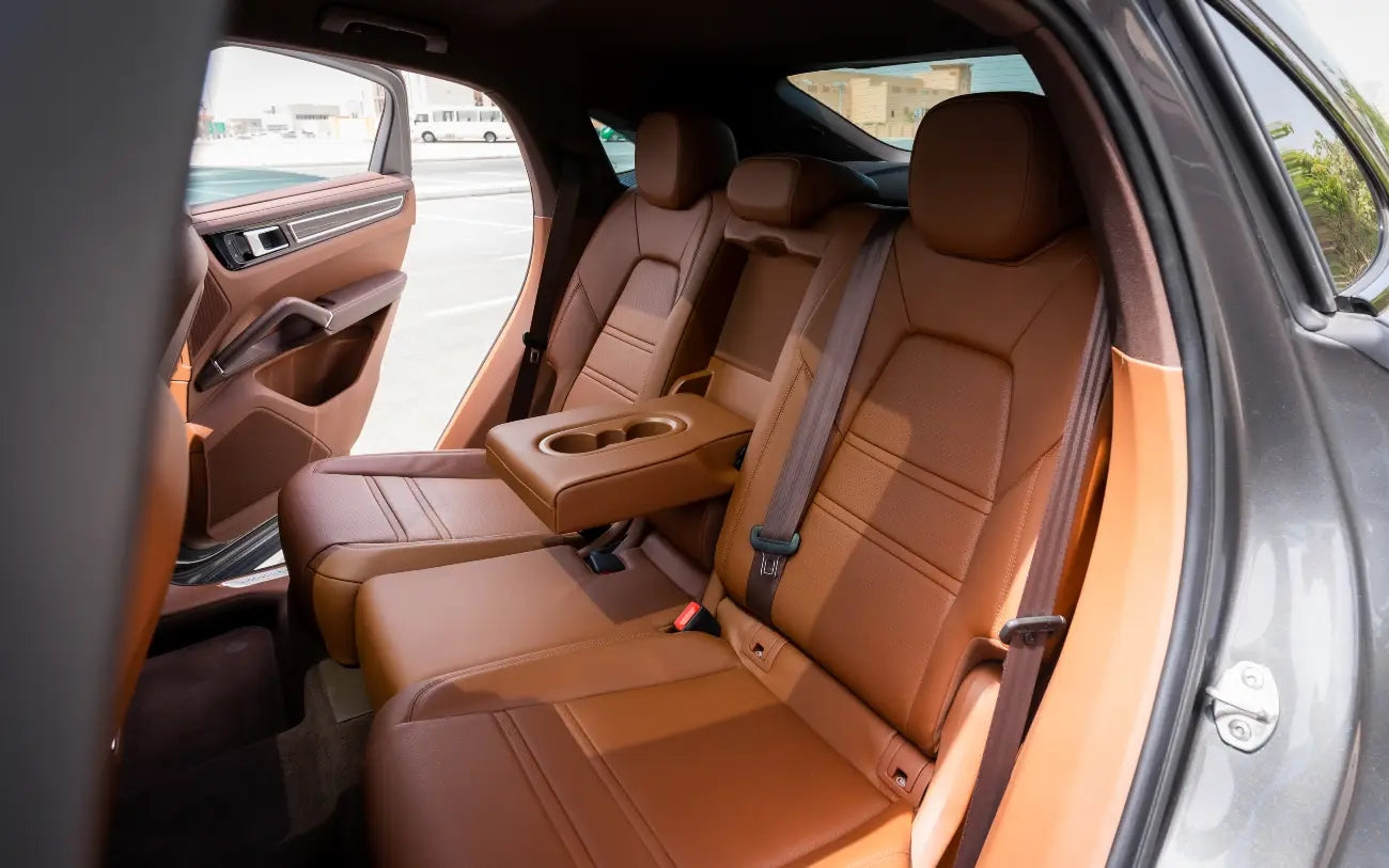 Porsche Cayenne Coupe on a desert road near Dubai, highlighting the adventurous spirit of this luxury SUV rental.