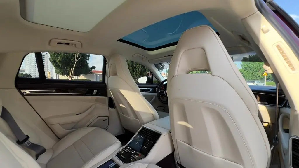 Side profile of a Porsche Panamera for hire in Dubai, showcasing its dynamic lines and luxury sedan silhouette.