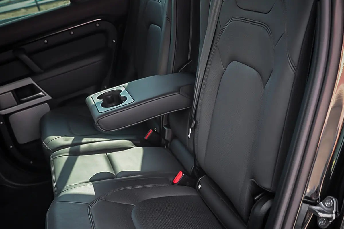 Elegant dashboard and state-of-the-art infotainment system inside a Range Rover Defender, available for rent in Dubai.