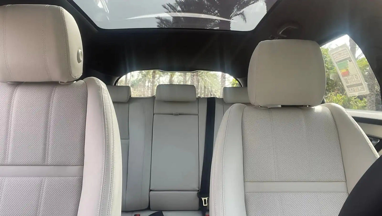 Close-up of the Range Rover Velar's alloy wheels and badge, detailing the luxury and status of this Dubai rental SUV.