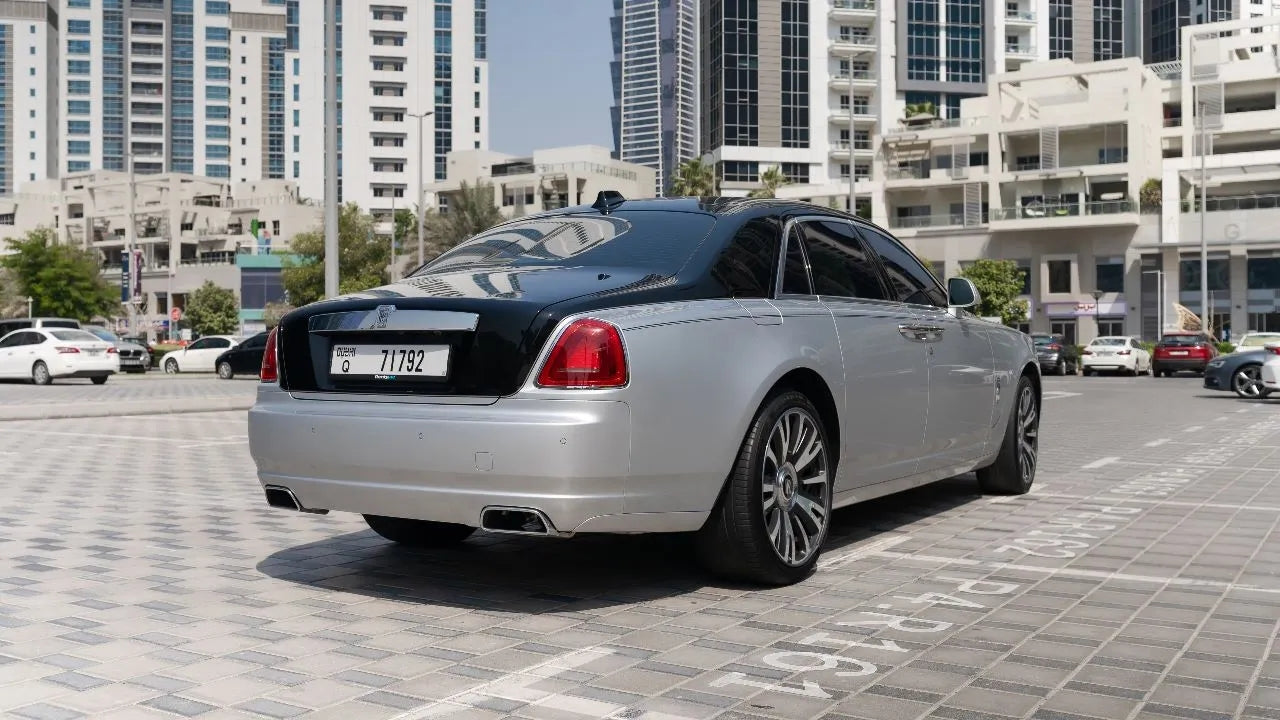 Rear angle of a sophisticated Rolls Royce Ghost, showcasing the luxury sedan's sleek lines for rent in Dubai.