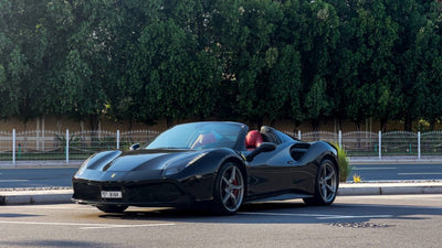 Luxury red Ferrari 488 Spyder rental, showcasing its sleek design and sporty profile, available in Dubai.