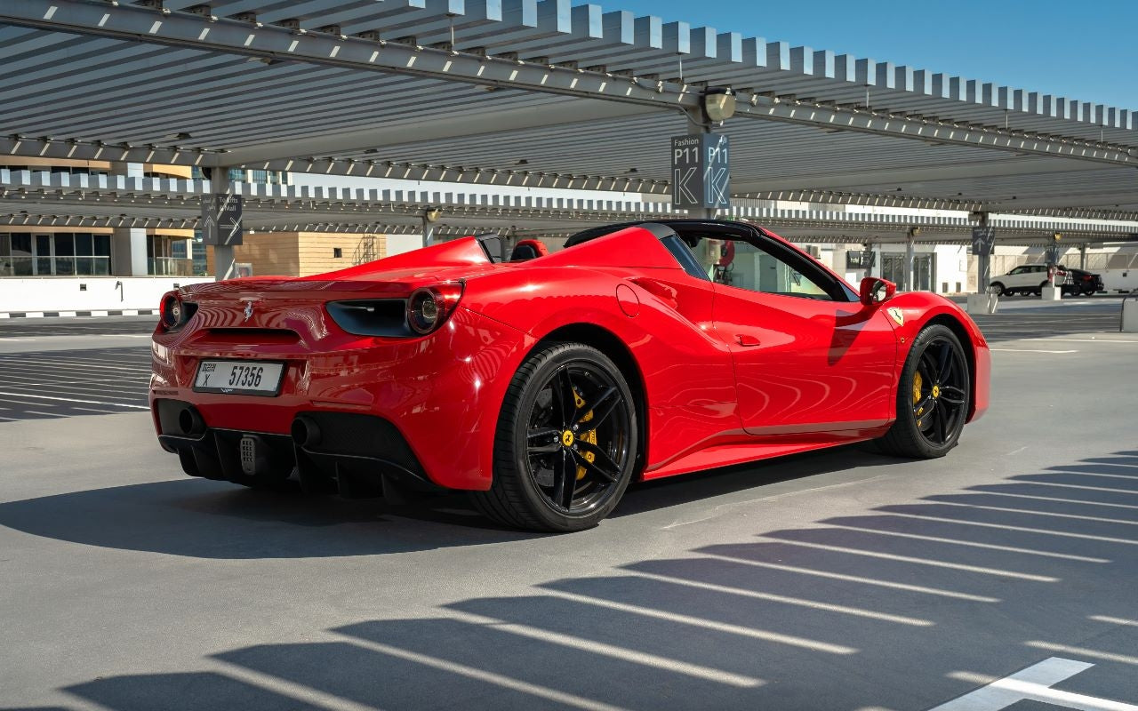 Rear angle of a Ferrari 488 Spyder available for rent, displaying its powerful exhaust system and stylish taillights in Dubai.