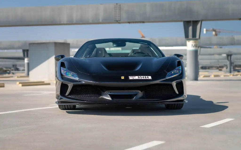 Luxury rental in Dubai - Close-up of the Ferrari F8 Tributo Spyder's stylish LED headlights and front grille.