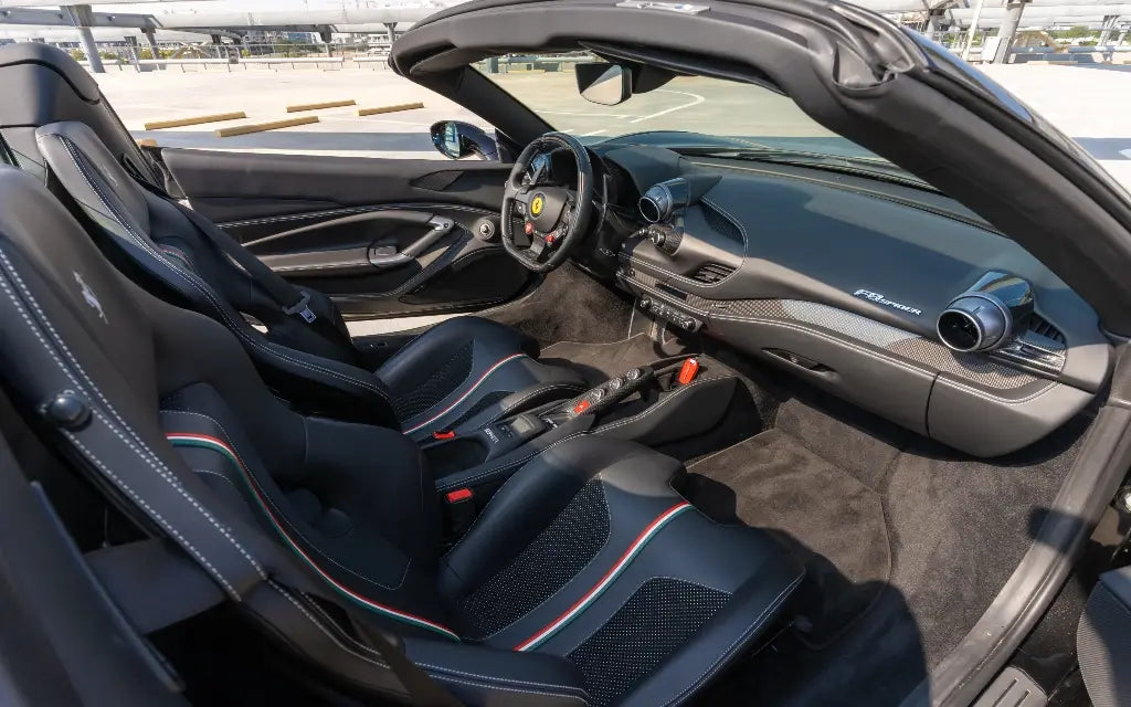 Side profile of the Ferrari F8 Tributo Spyder, capturing the dynamic lines and high-performance wheels, offered for rental in Dubai.