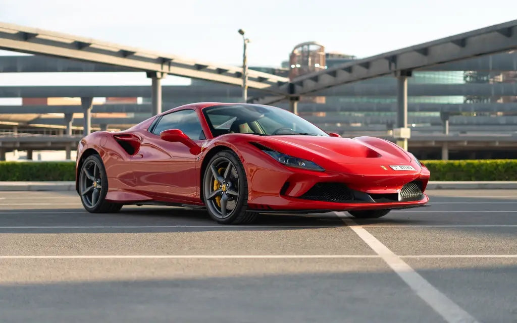 Red Ferrari F8 Tributo Spyder front view parked, showcasing sleek design - Luxury car rental in Dubai.
