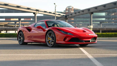 Red Ferrari F8 Tributo Spyder front view parked, showcasing sleek design - Luxury car rental in Dubai.